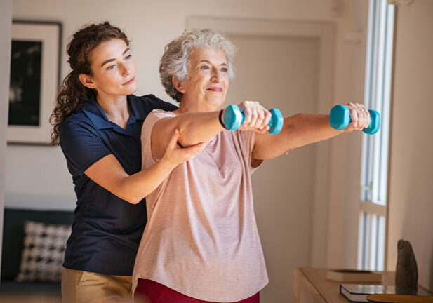 Woman helping a senior work out